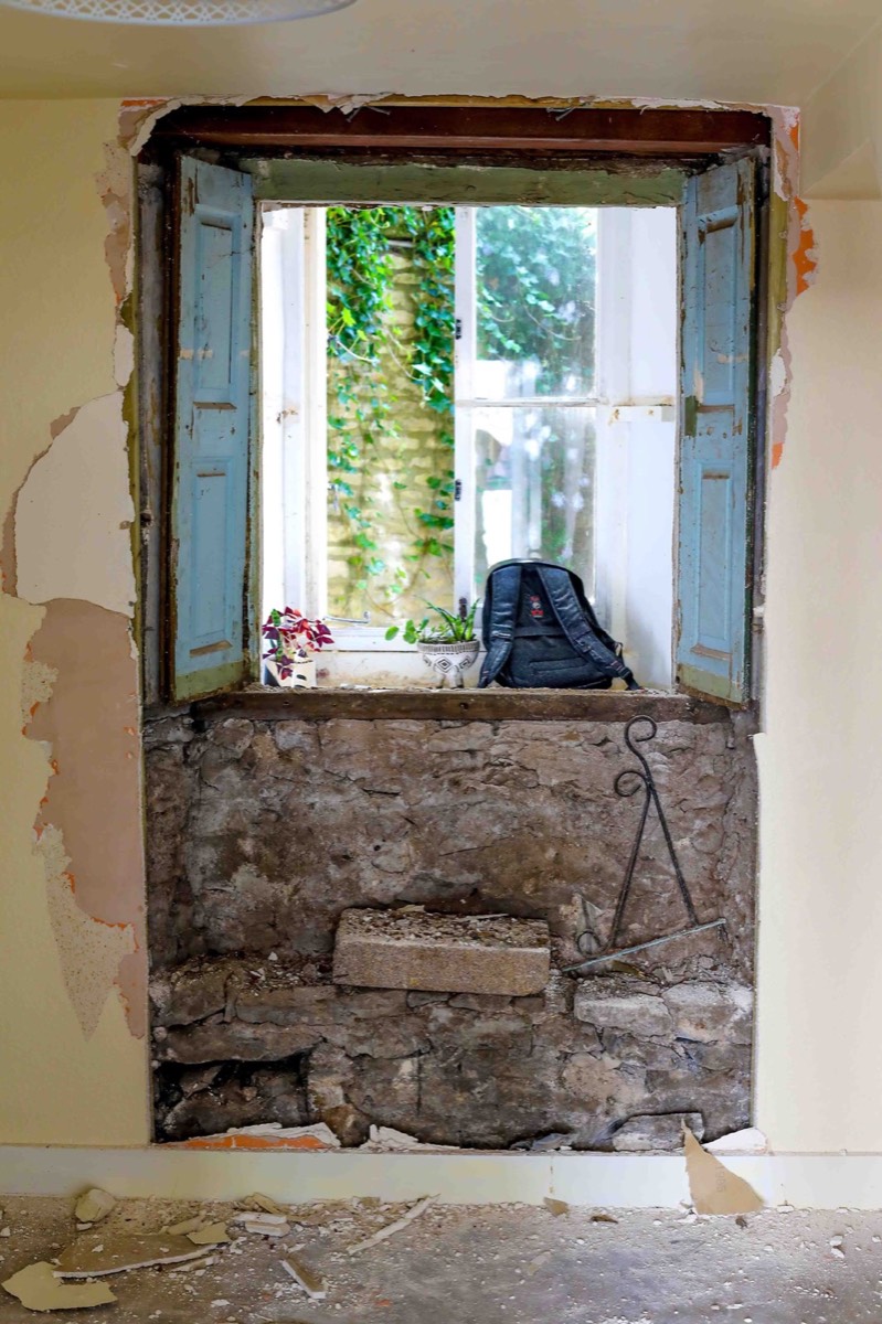 An interior window at No. 10, with exposed masonry below.